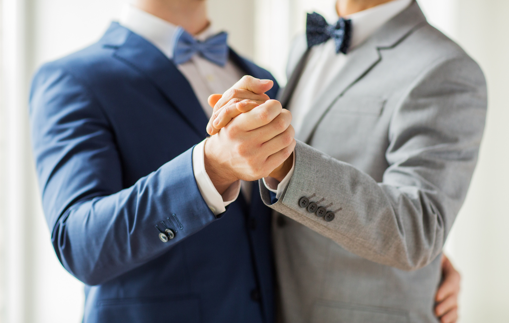 close up of happy male gay couple dancing Mariage Gai Lyon Unidyl